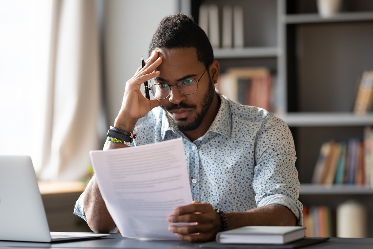 Business owner frustrated by common examples of insurance frauds